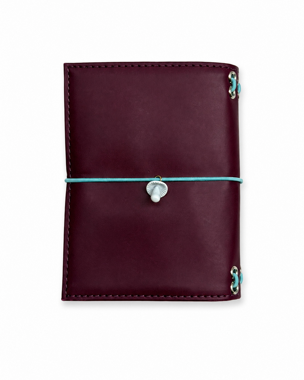 Back view of the Burgundy pocket journal with a powder-blue elastic closure and mushroom band charm