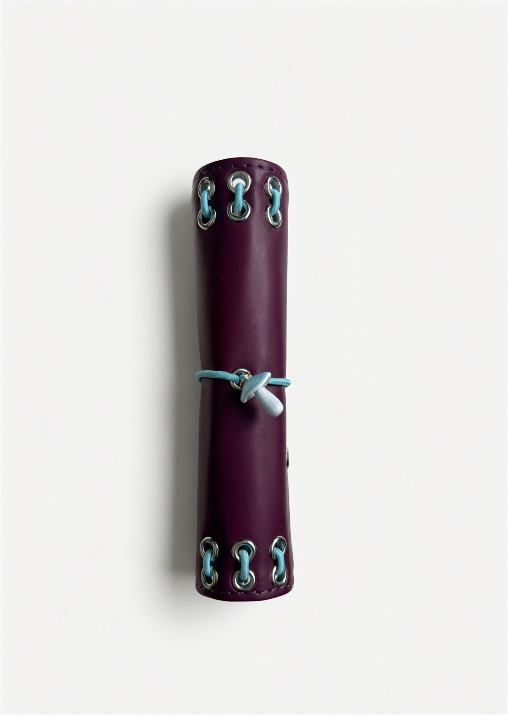 Side view of the closed Burgundy pocket journal showing its compact size and metal eyelet details