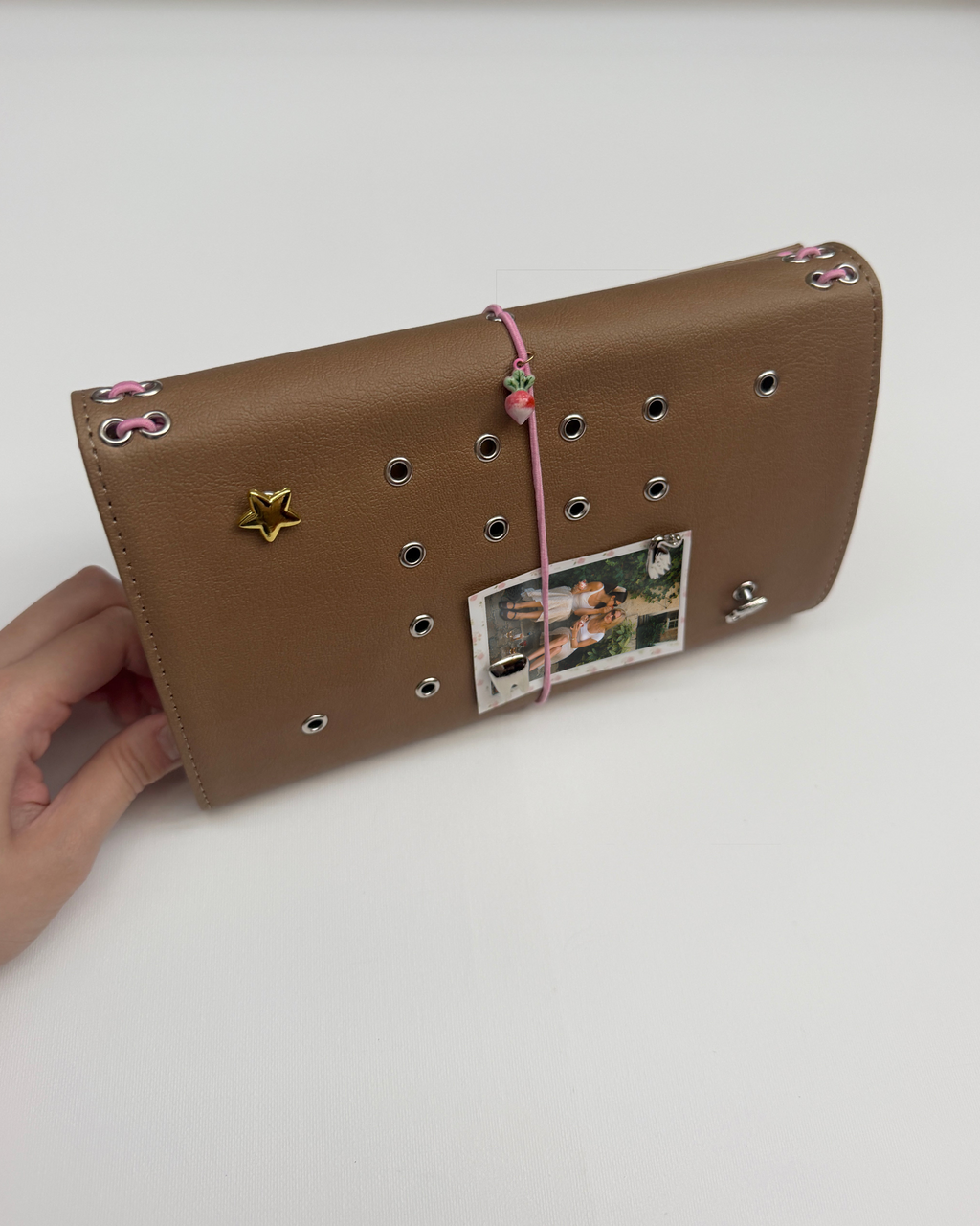 Camel Radish full size journal displayed horizontally with a personal photo, blush-pink elastic band, pink radish charm, and removable KEPT cover charms.