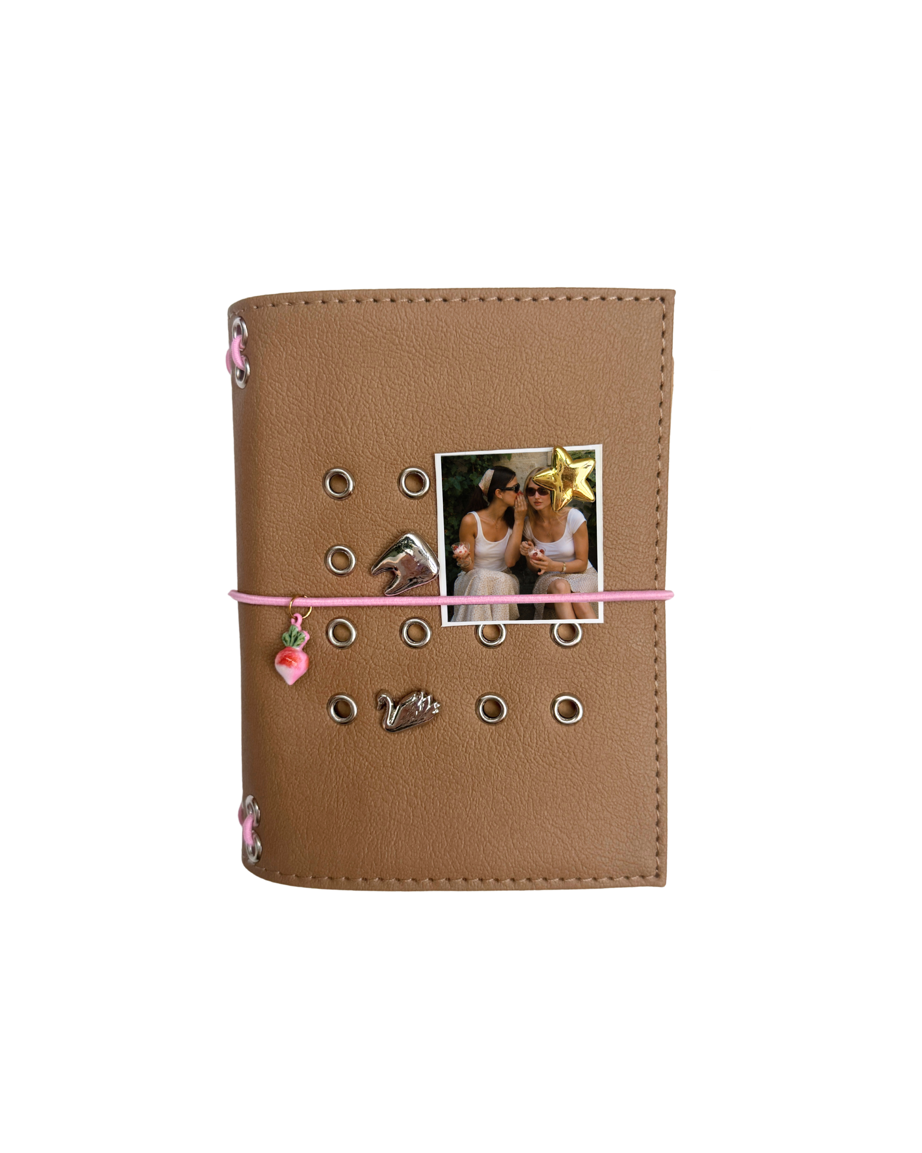Front view of the Camel Radish Pocket Journal with a textured PU cover, blush-pink elastic band, pink radish charm, metal eyelets, and four removable KEPT cover charms.