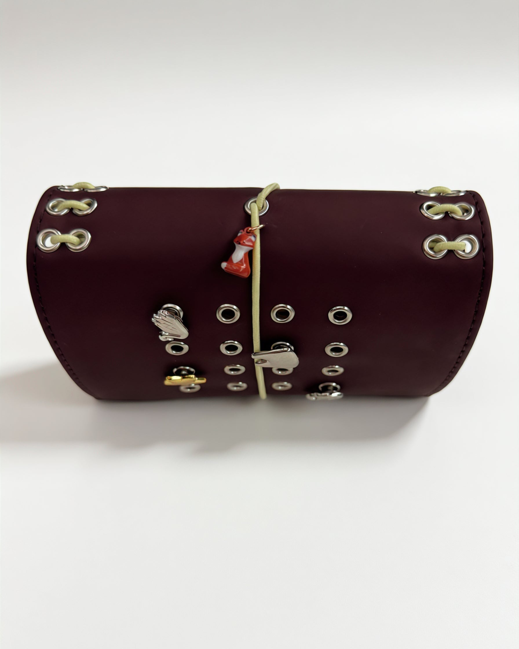 Chestnut Fox pocket journal displayed horizontally with a butter-yellow elastic closure, fox charm, and removable KEPT cover charms
