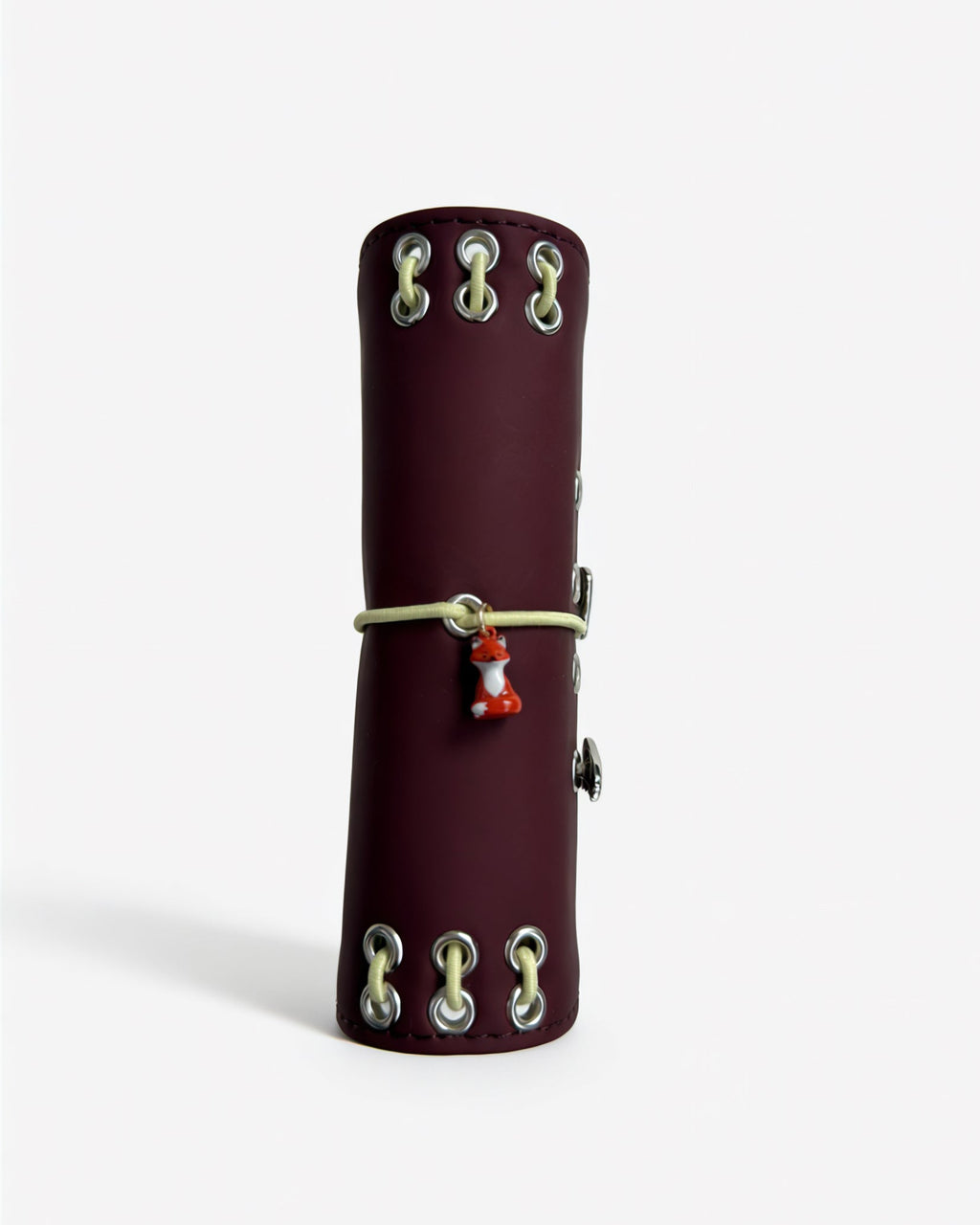 Spine view of the Chestnut Fox pocket journal showing contrast lacing, metal eyelets, elastic band, and fox charm
