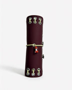 Spine view of the Chestnut Fox pocket journal showing contrast lacing, metal eyelets, elastic band, and fox charm
