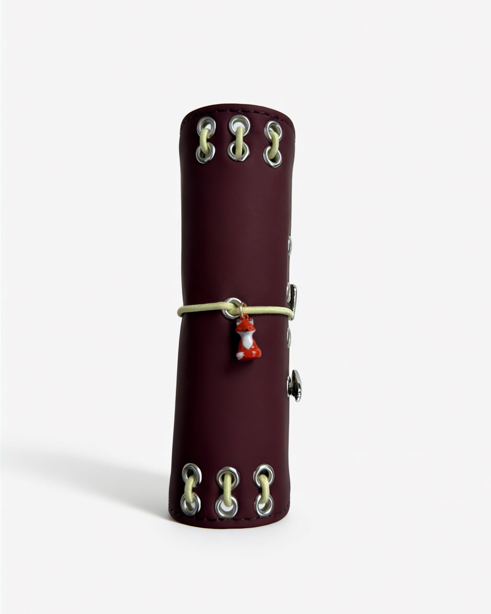 Spine view of the Chestnut Fox pocket journal showing contrast lacing, metal eyelets, elastic band, and fox charm
