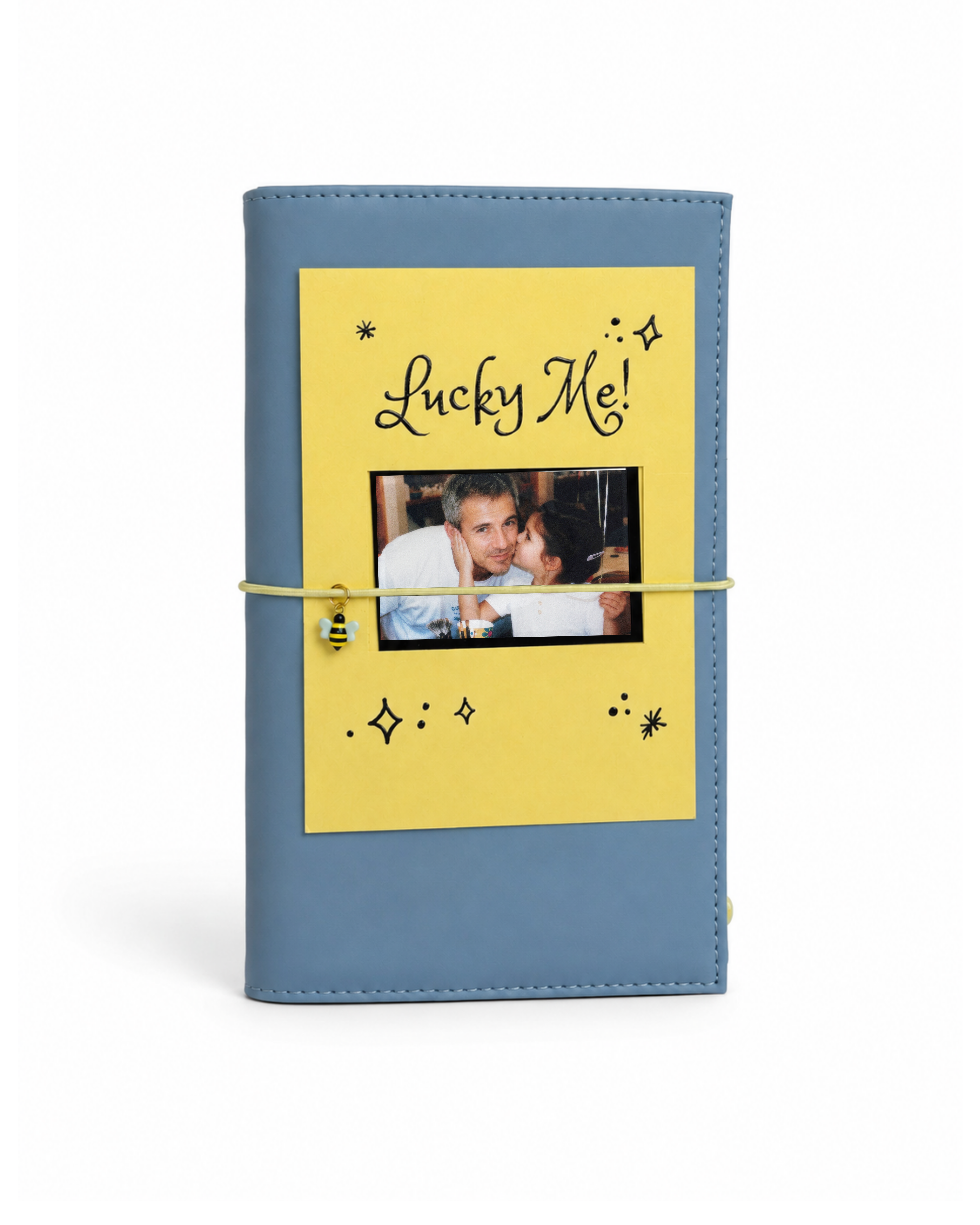 Back view of the Mist Blue full size journal styled with its “Lucky Me!” gold-foil photo keepsake card.
