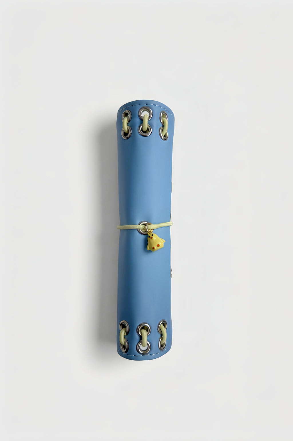 Side view of the closed Mist Blue pocket journal showing its compact profile and yellow chick charm