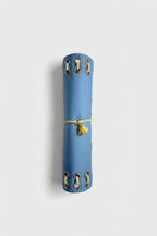 Side view of the closed Mist Blue pocket journal showing its compact profile and yellow chick charm