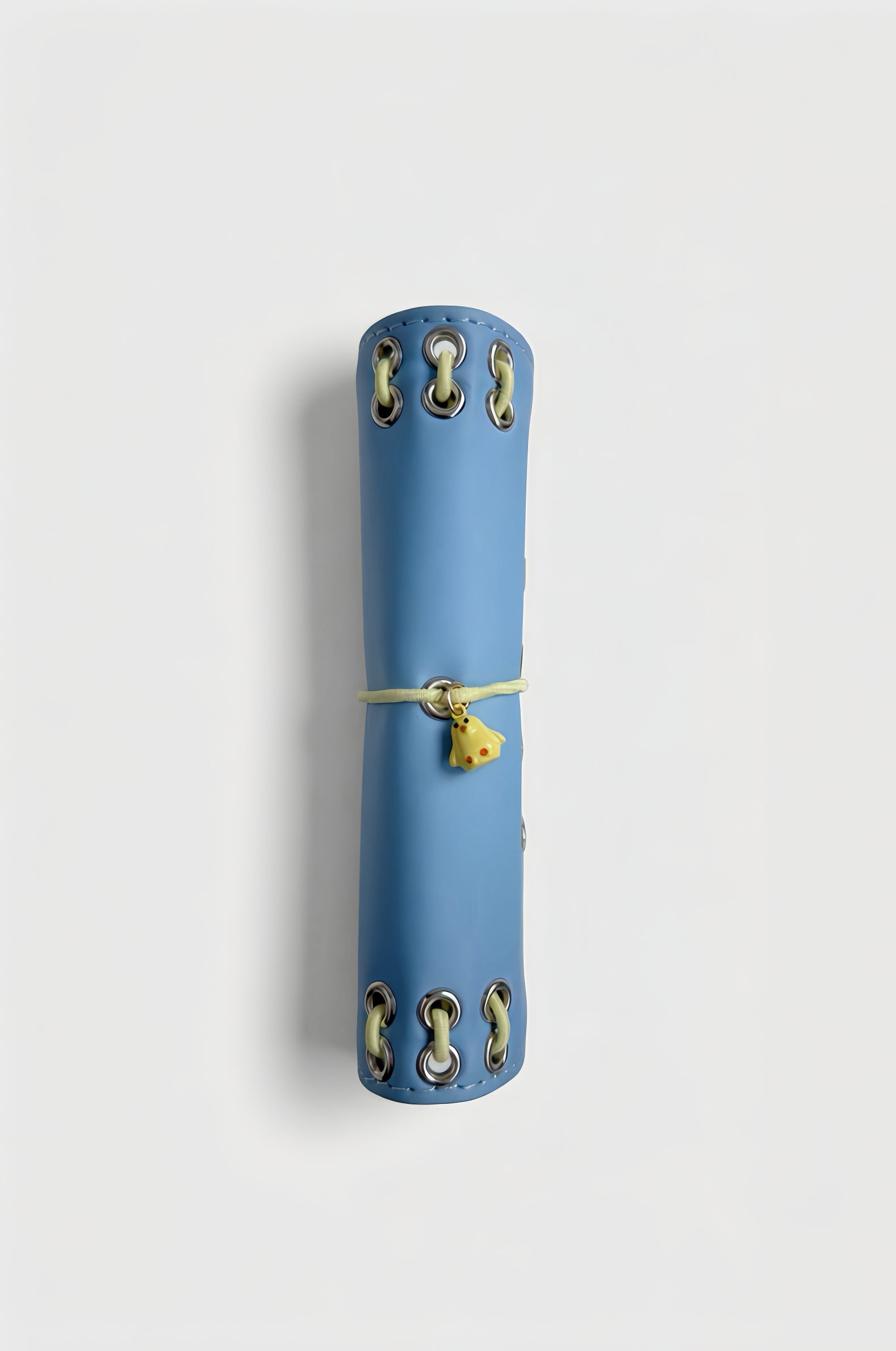 Side view of the closed Mist Blue pocket journal showing its compact profile and yellow chick charm