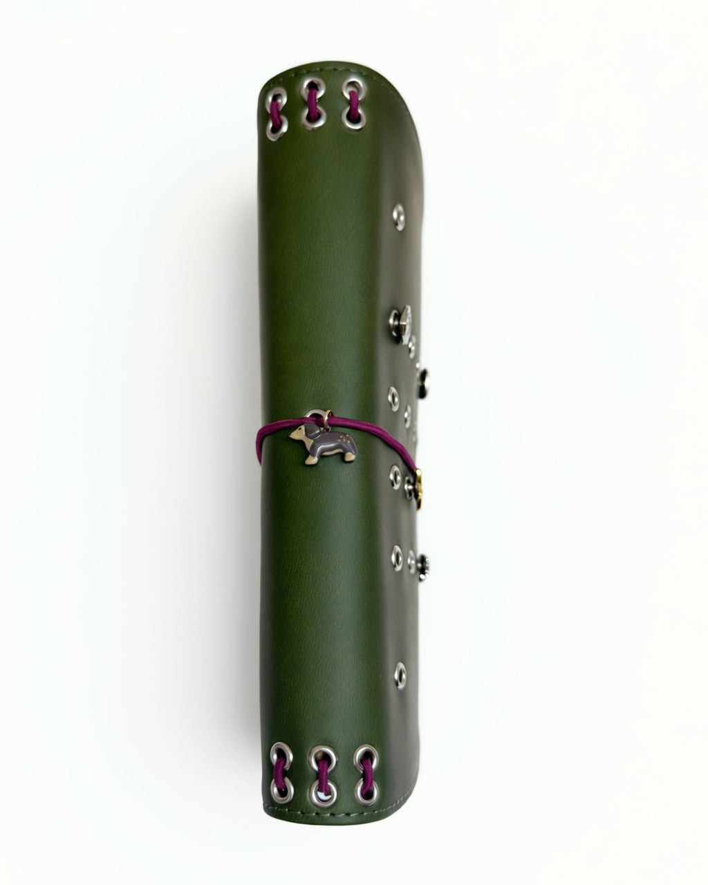Olive full size journal shown from the side with burgundy cord binding, silver eyelets, dachshund charm, and removable KEPT cover charms.