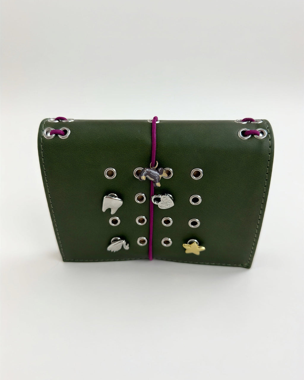Olive pocket journal displayed horizontally with a burgundy elastic closure, dachshund charm, and removable KEPT cover charms