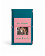 Teal Full Size Journal with a blush-pink elastic band and a pink “This Moment / Again & Again” photo keepsake card on a white background.